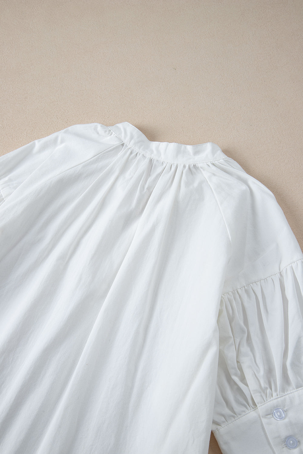 White Solid Color Ruched Bubble Sleeve V Neck ShirtMaterial:100%Cotton

• The ruched detailing on the sleeves adds a touch of texture and visual interest, making this top a standout choice for any occasion. 
• Craf