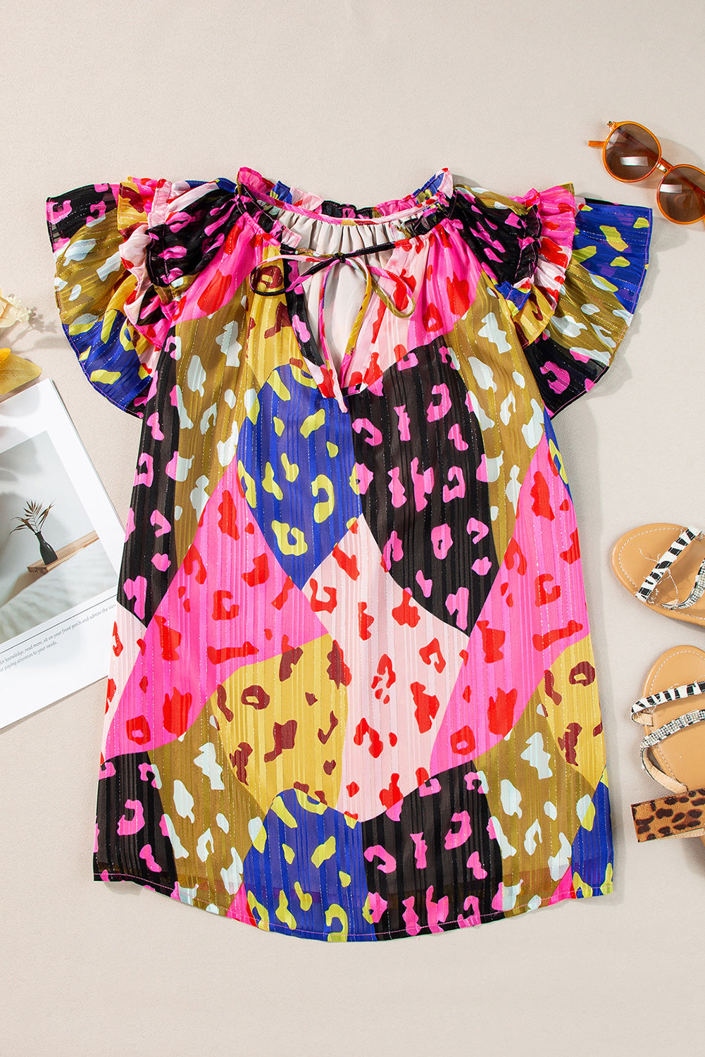 Multicolour Leopard Flutter Sleeve V Neck Crinkled BlouseMaterial:100%Polyester

• Stand out in style with this blouse, perfect for adding a touch of wild elegance to your wardrobe.
• The vibrant multicolored leopard pri