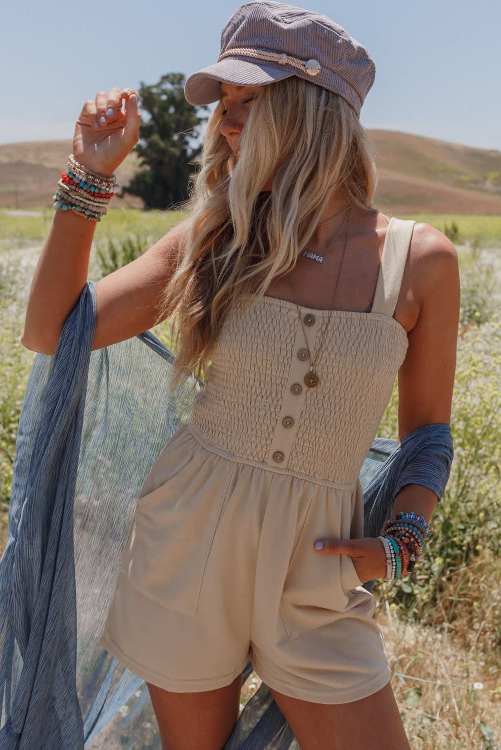 Beige Solid Color Buttons Smocked Sleeveless RomperMaterial:85%Polyester+10%Cotton+5%Elastane

• Its high waist design adds a flattering touch to any silhouette.
• Embrace the versatility of this romper with its sl