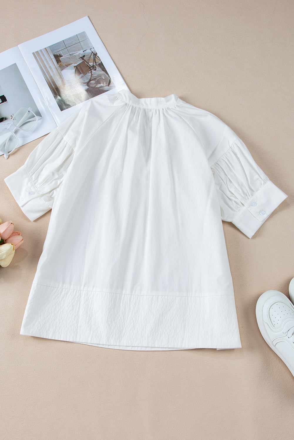 White Solid Color Ruched Bubble Sleeve V Neck ShirtMaterial:100%Cotton

• The ruched detailing on the sleeves adds a touch of texture and visual interest, making this top a standout choice for any occasion. 
• Craf