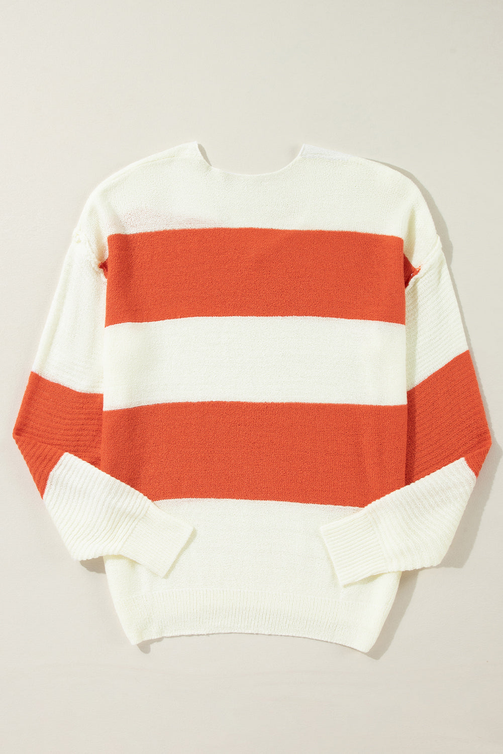 Orange Colorblock V Neck Side Slits SweaterMaterial:100%Acrylic

• Stand out in style with our sweater, blending casual stripes with a trendy rib-knit design.
• The vibrant orange hues add a pop of color to