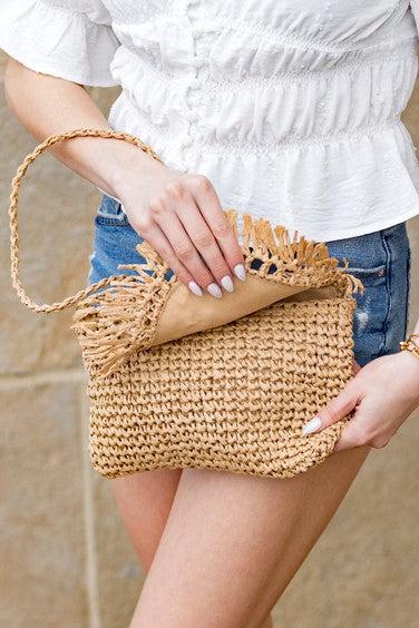 Sofia Foldover Straw Crossbody BagSofia Foldover Straw CrossbodyFold Over FlapHand Tied Rattan Edge DetailMeasurement: 6.5"x10"Woven Straw ExteriorLined Interior: 30% Cotton/70% PolyesterAttached Wov