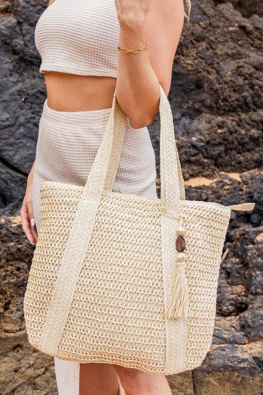 Izola Carry All Tassel ToteIzola Carry All Tassel ToteDETAILSWoven Straw Exterior Wooden Bead/Straw Tassel AccentExterior: StrawLined Interior: 30% Cotton/70% PolyesterMeasurements: 15.75"x17"