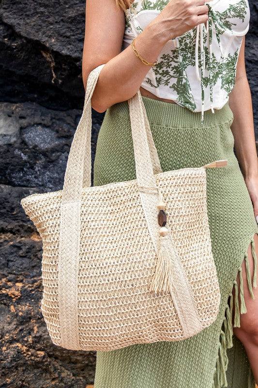 Izola Carry All Tassel ToteIzola Carry All Tassel ToteDETAILSWoven Straw Exterior Wooden Bead/Straw Tassel AccentExterior: StrawLined Interior: 30% Cotton/70% PolyesterMeasurements: 15.75"x17"