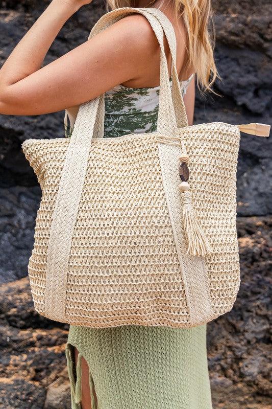 Izola Carry All Tassel ToteIzola Carry All Tassel ToteDETAILSWoven Straw Exterior Wooden Bead/Straw Tassel AccentExterior: StrawLined Interior: 30% Cotton/70% PolyesterMeasurements: 15.75"x17"