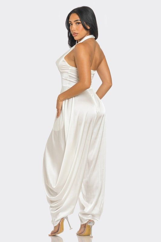 Ivory Serenity JumpsuitStep into the spotlight with our Ivory Serenity Jumpsuit, designed for the woman who embodies grace and style. This exquisite piece combines the sophistication of a 