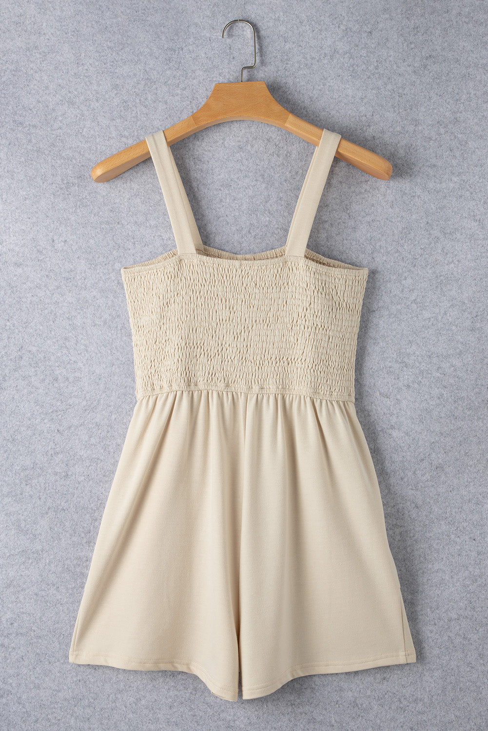 Beige Solid Color Buttons Smocked Sleeveless RomperMaterial:85%Polyester+10%Cotton+5%Elastane

• Its high waist design adds a flattering touch to any silhouette.
• Embrace the versatility of this romper with its sl