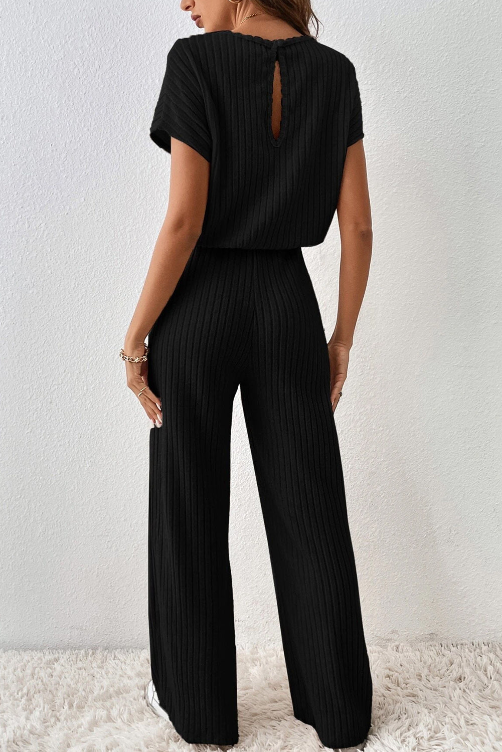 Grass Green Solid Color Ribbed Short Sleeve Wide Leg JumpsuitMaterial:85%Polyester+10%Viscose+5%Elastane



		The jumpsuit is a versatile and trendy one-piece outfit, featuring a solid color design that offers a sleek and mi