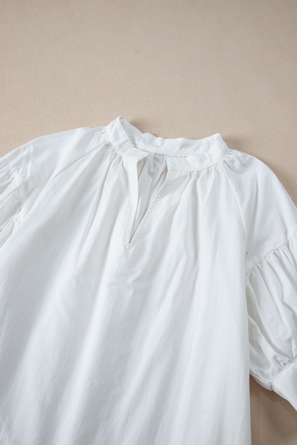White Solid Color Ruched Bubble Sleeve V Neck ShirtMaterial:100%Cotton

• The ruched detailing on the sleeves adds a touch of texture and visual interest, making this top a standout choice for any occasion. 
• Craf