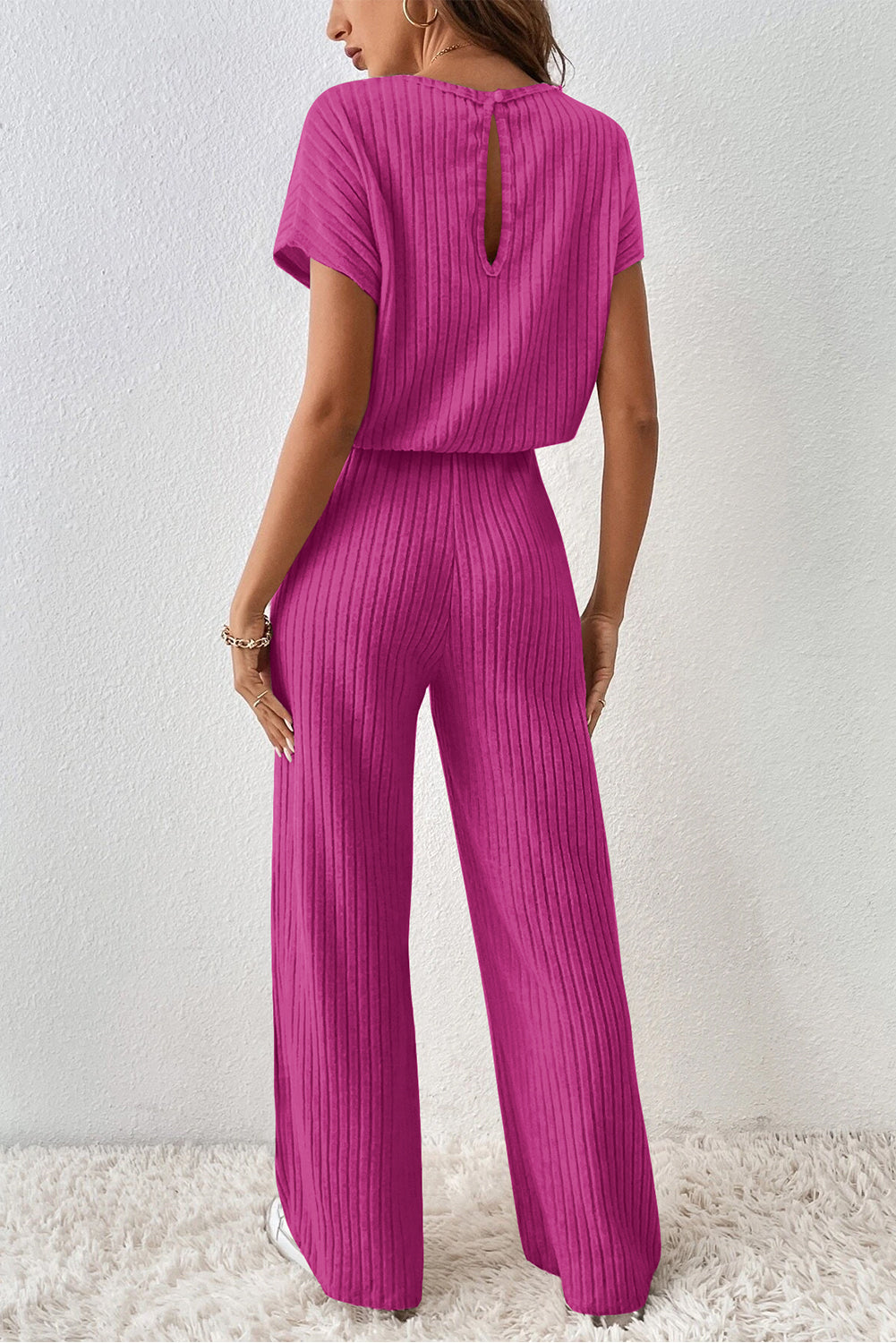 Grass Green Solid Color Ribbed Short Sleeve Wide Leg JumpsuitMaterial:85%Polyester+10%Viscose+5%Elastane



		The jumpsuit is a versatile and trendy one-piece outfit, featuring a solid color design that offers a sleek and mi