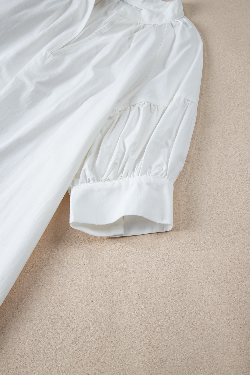 White Solid Color Ruched Bubble Sleeve V Neck ShirtMaterial:100%Cotton

• The ruched detailing on the sleeves adds a touch of texture and visual interest, making this top a standout choice for any occasion. 
• Craf