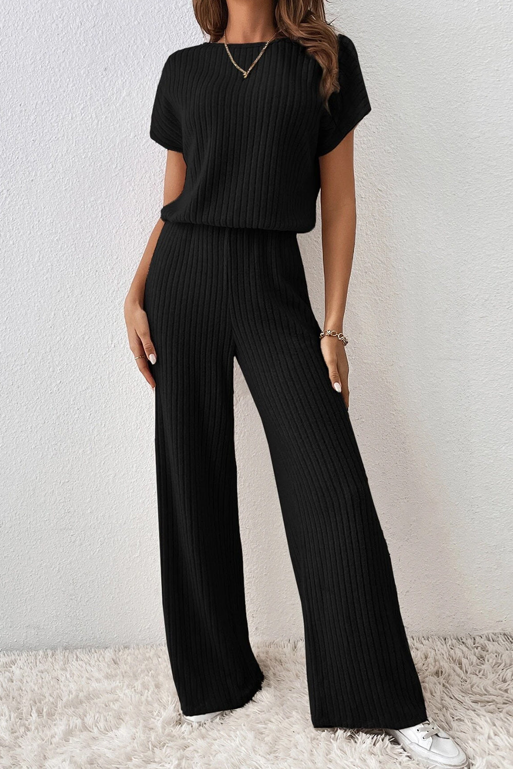 Grass Green Solid Color Ribbed Short Sleeve Wide Leg JumpsuitMaterial:85%Polyester+10%Viscose+5%Elastane



		The jumpsuit is a versatile and trendy one-piece outfit, featuring a solid color design that offers a sleek and mi