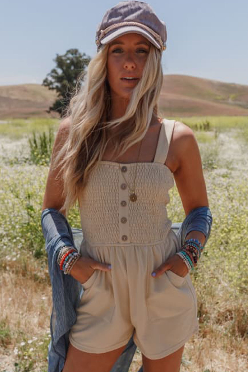 Beige Solid Color Buttons Smocked Sleeveless RomperMaterial:85%Polyester+10%Cotton+5%Elastane

• Its high waist design adds a flattering touch to any silhouette.
• Embrace the versatility of this romper with its sl