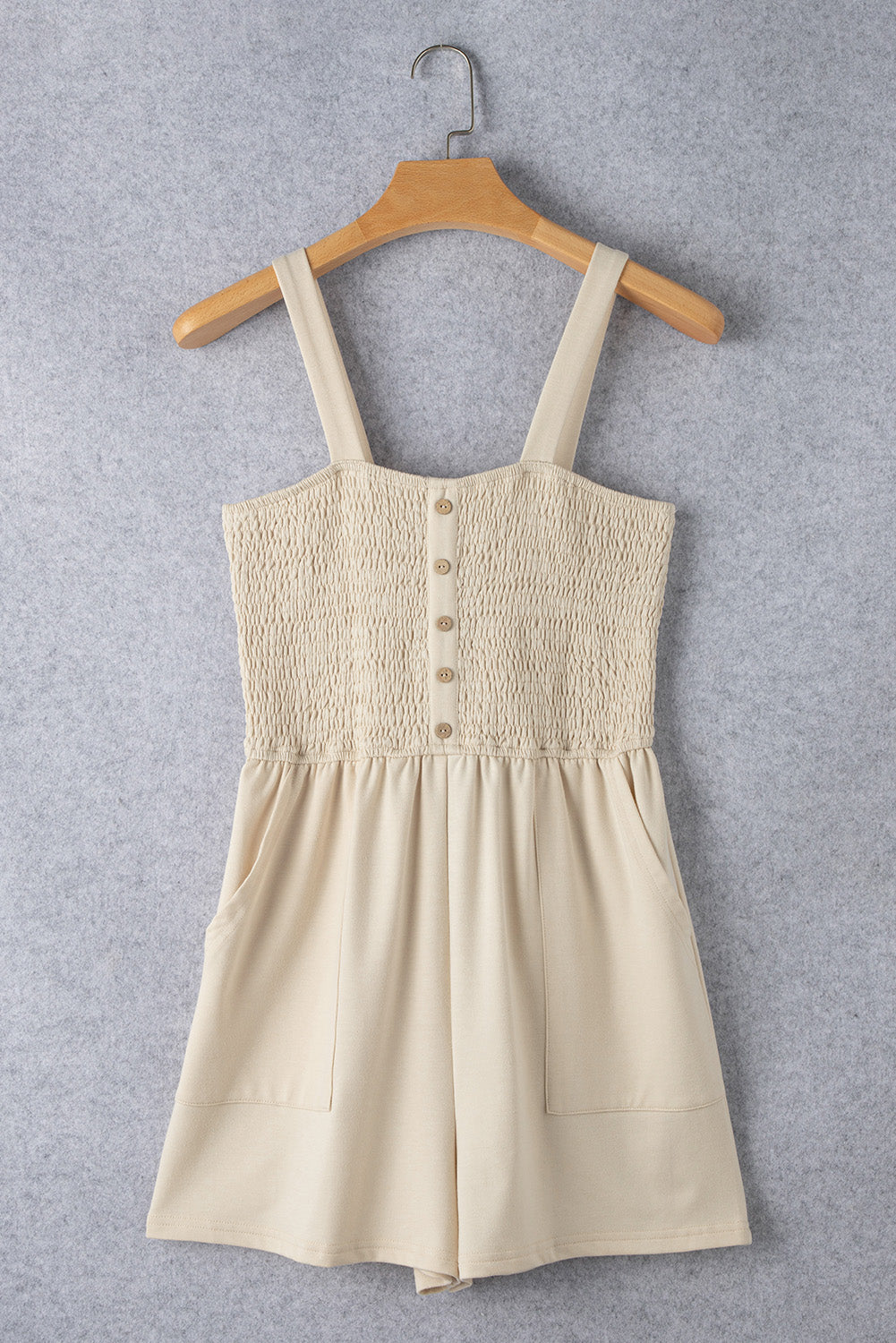 Beige Solid Color Buttons Smocked Sleeveless RomperMaterial:85%Polyester+10%Cotton+5%Elastane

• Its high waist design adds a flattering touch to any silhouette.
• Embrace the versatility of this romper with its sl