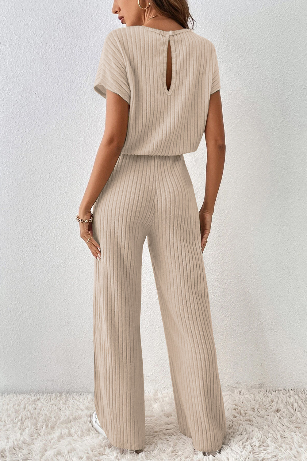 Grass Green Solid Color Ribbed Short Sleeve Wide Leg JumpsuitMaterial:85%Polyester+10%Viscose+5%Elastane



		The jumpsuit is a versatile and trendy one-piece outfit, featuring a solid color design that offers a sleek and mi
