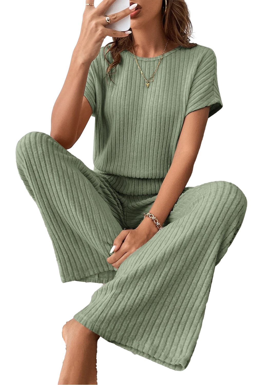 Grass Green Solid Color Ribbed Short Sleeve Wide Leg JumpsuitMaterial:85%Polyester+10%Viscose+5%Elastane



		The jumpsuit is a versatile and trendy one-piece outfit, featuring a solid color design that offers a sleek and mi
