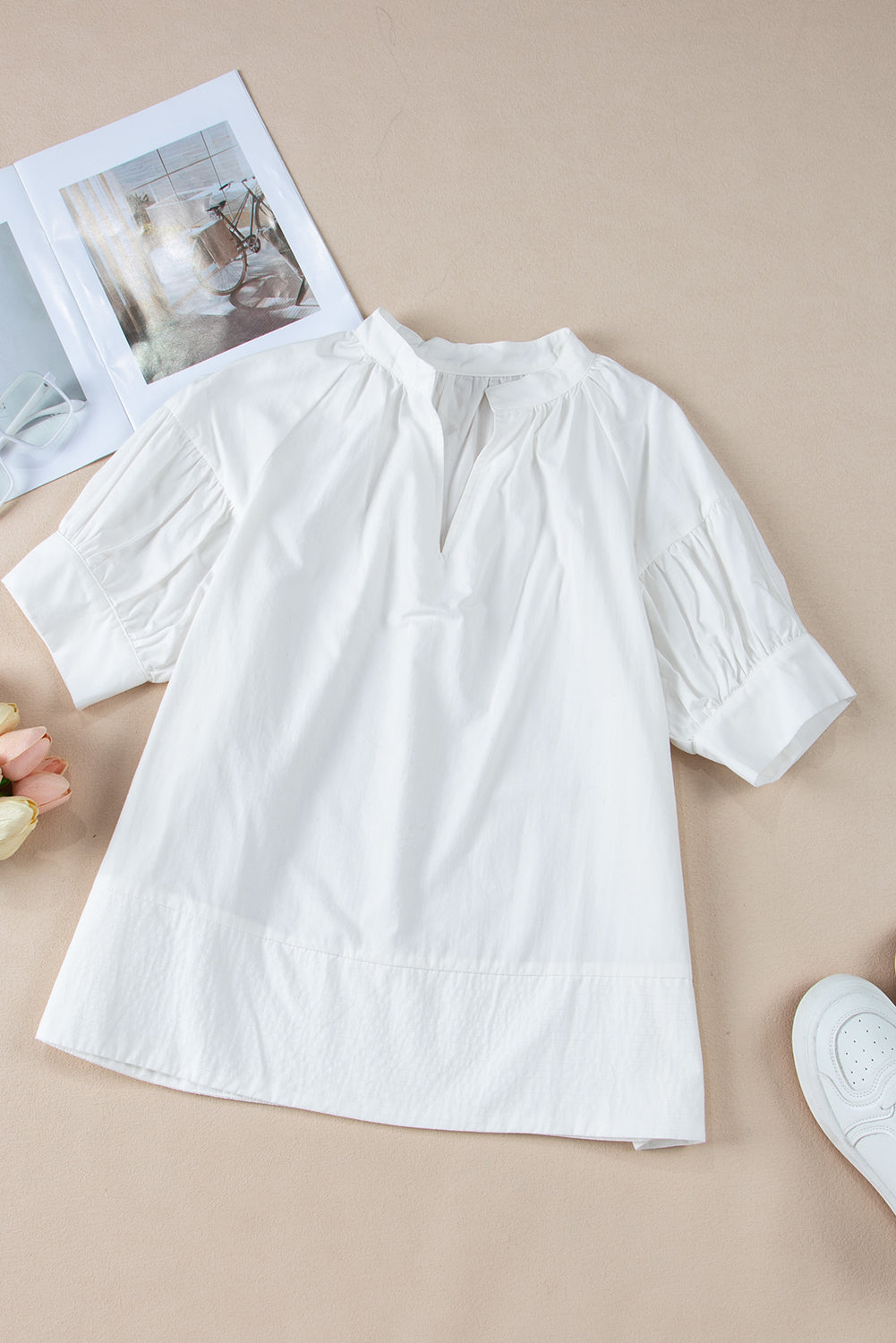 White Solid Color Ruched Bubble Sleeve V Neck ShirtMaterial:100%Cotton

• The ruched detailing on the sleeves adds a touch of texture and visual interest, making this top a standout choice for any occasion. 
• Craf