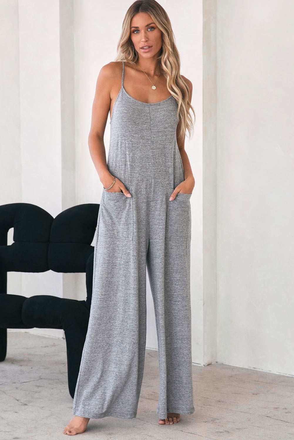 Gray Loose Fit Side Pockets Spaghetti Strap Wide Leg JumpsuitMaterial:65%Polyester+30%Cotton+5%Elastane



		Featuring a loose fit, the wide leg
jumpsuit provides freedom of movement
	
	
		Spaghetti straps highlight wome