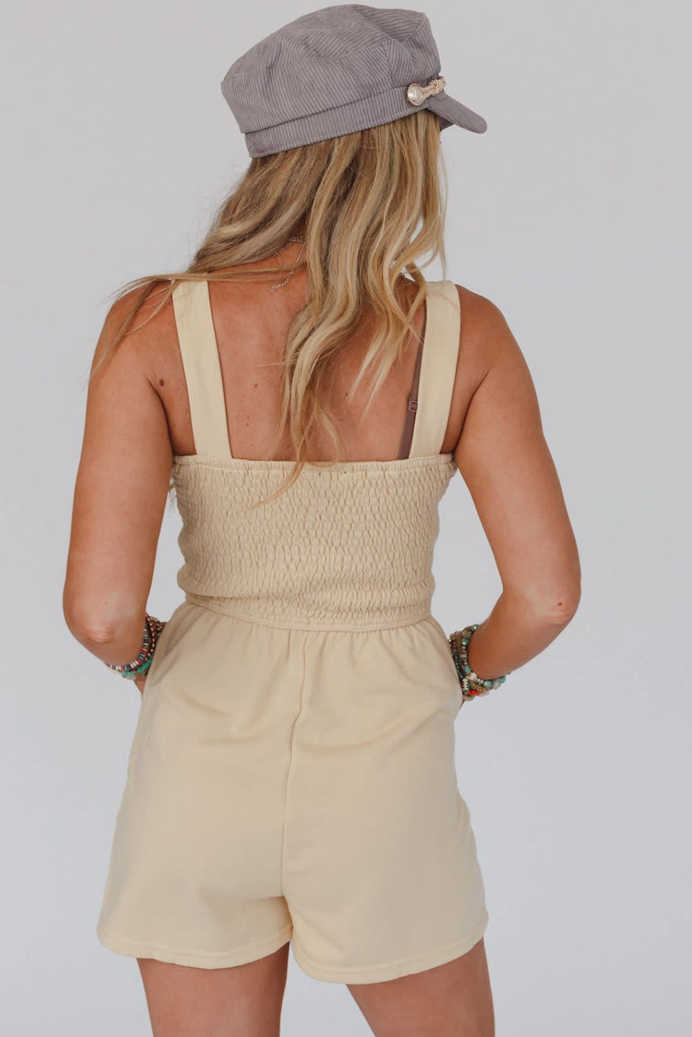 Beige Solid Color Buttons Smocked Sleeveless RomperMaterial:85%Polyester+10%Cotton+5%Elastane

• Its high waist design adds a flattering touch to any silhouette.
• Embrace the versatility of this romper with its sl