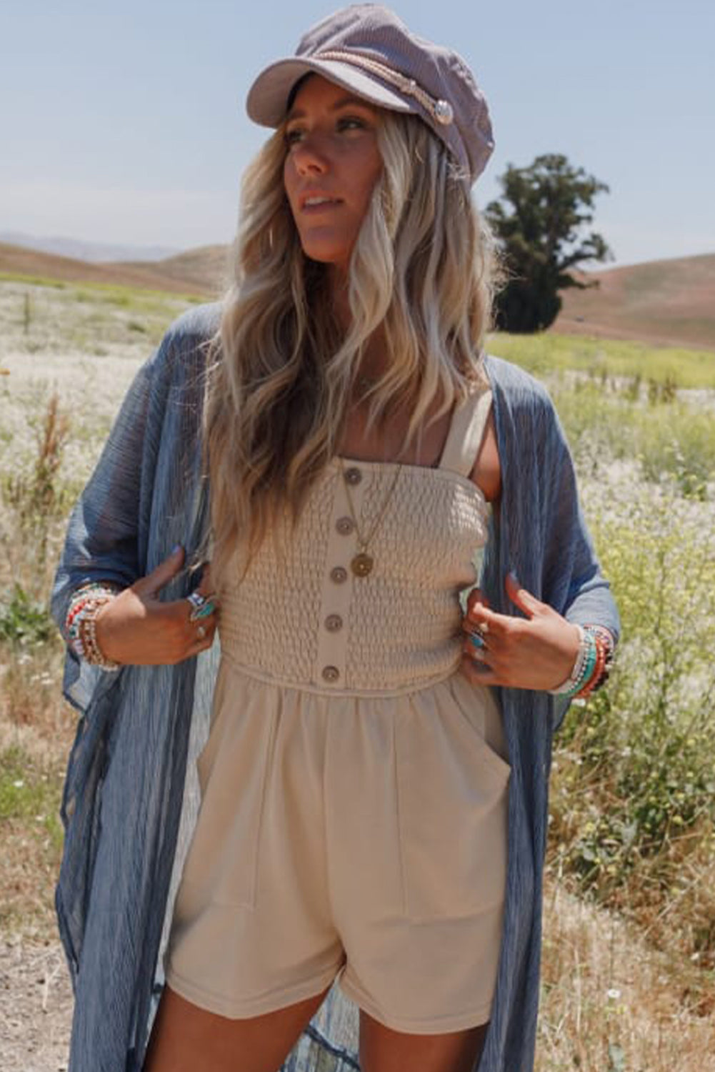 Beige Solid Color Buttons Smocked Sleeveless RomperMaterial:85%Polyester+10%Cotton+5%Elastane

• Its high waist design adds a flattering touch to any silhouette.
• Embrace the versatility of this romper with its sl