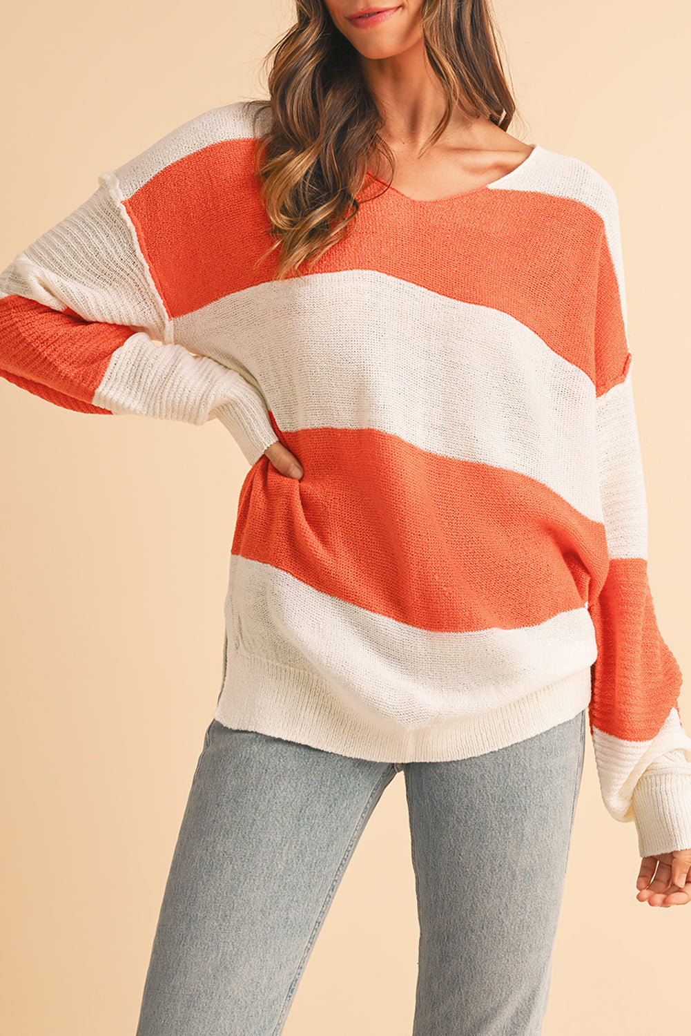 Orange Colorblock V Neck Side Slits SweaterMaterial:100%Acrylic

• Stand out in style with our sweater, blending casual stripes with a trendy rib-knit design.
• The vibrant orange hues add a pop of color to