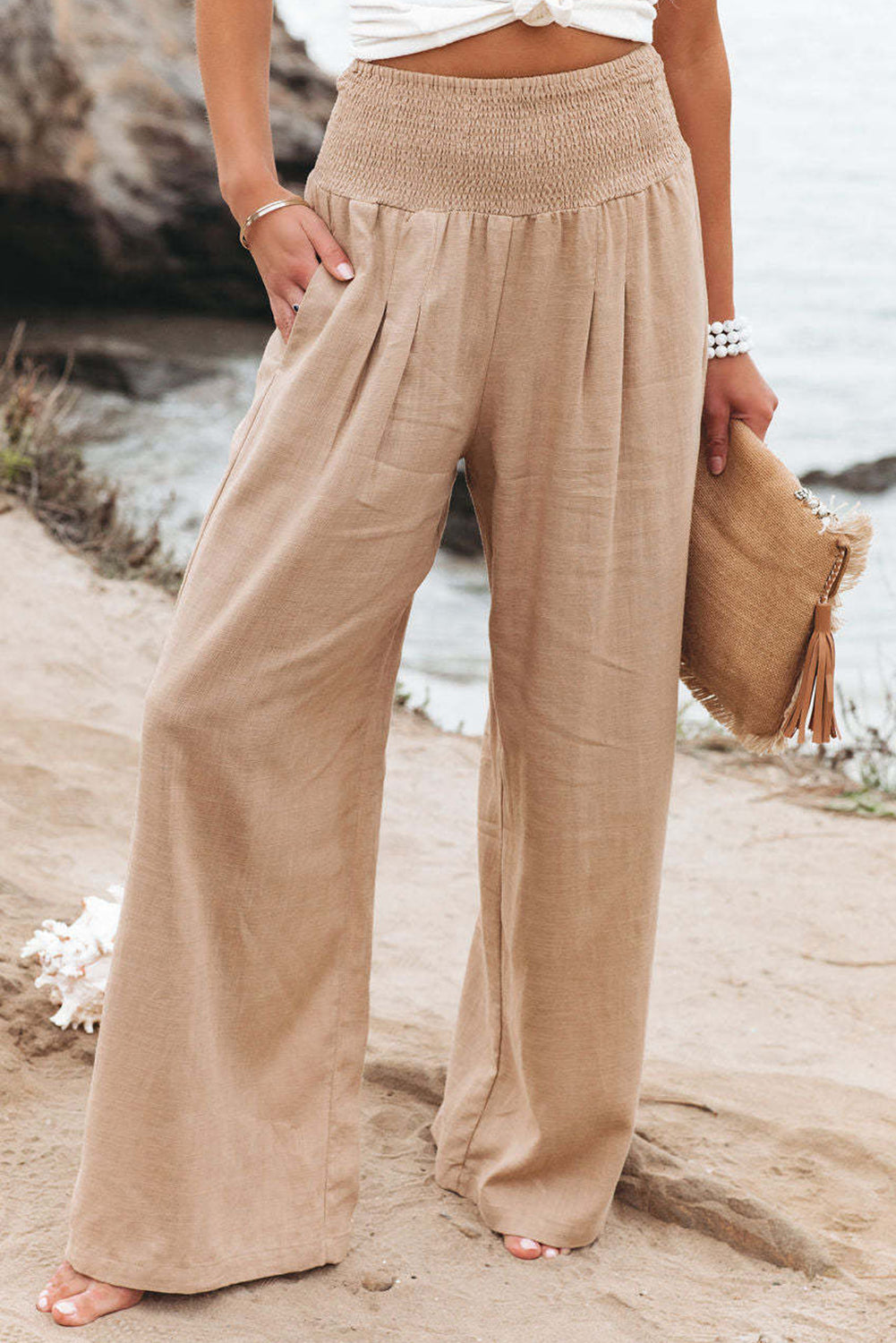 Black Smocked Wide Waistband High Waist Wide Leg PantsMaterial:65%COTTON+35%POLYESTER



		Flattering smocked waistband cinches at the
waist for a lovely silhouette
	
	
		High waist design elongates legs for a
st