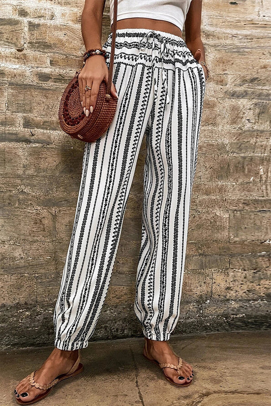 Black Stripe Geometric Print Drawstring Cuff PantsStylish black stripes for a modern touch
	
	
		Convenient pockets for practicality
	
	
		Adjustable drawstring cuff for a personalized fit
	
	
		Geometric p