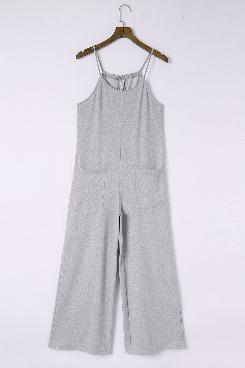Gray Loose Fit Side Pockets Spaghetti Strap Wide Leg JumpsuitMaterial:65%Polyester+30%Cotton+5%Elastane



		Featuring a loose fit, the wide leg
jumpsuit provides freedom of movement
	
	
		Spaghetti straps highlight wome