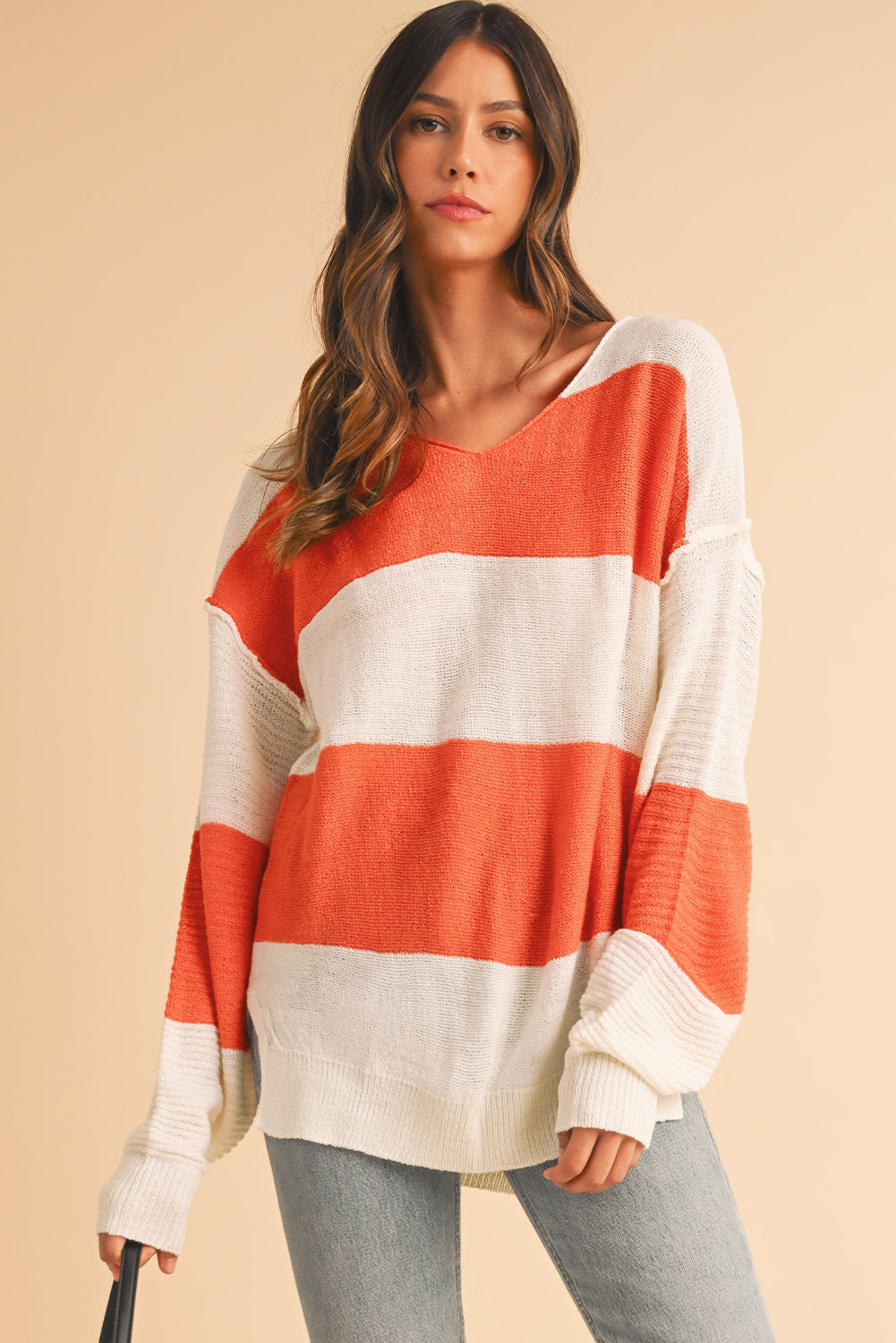 Orange Colorblock V Neck Side Slits SweaterMaterial:100%Acrylic

• Stand out in style with our sweater, blending casual stripes with a trendy rib-knit design.
• The vibrant orange hues add a pop of color to