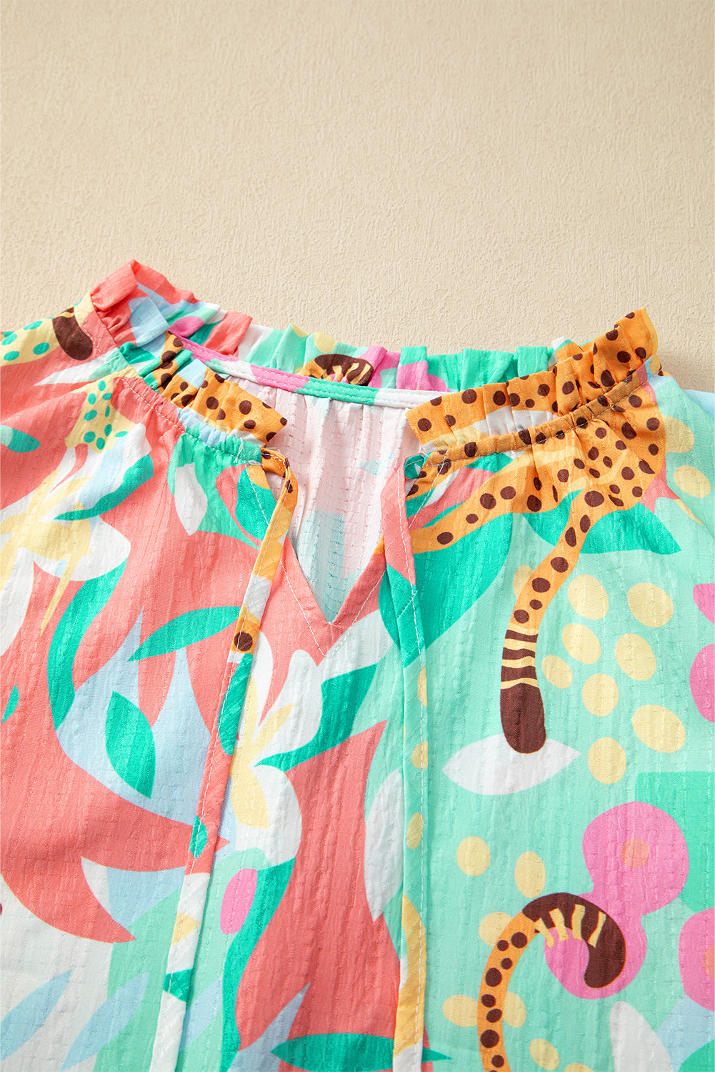 Green Tie Split Neck Ruffle Summer Cheetah Floral BlouseMaterial:100%Polyester

• Embrace the wild side of fashion with this blouse that effortlessly combines leopard print and floral patterns for a bold statement piece.