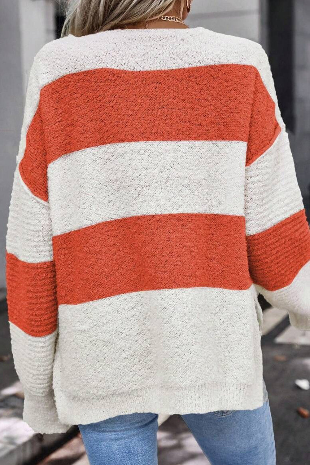 Orange Colorblock V Neck Side Slits SweaterMaterial:100%Acrylic

• Stand out in style with our sweater, blending casual stripes with a trendy rib-knit design.
• The vibrant orange hues add a pop of color to