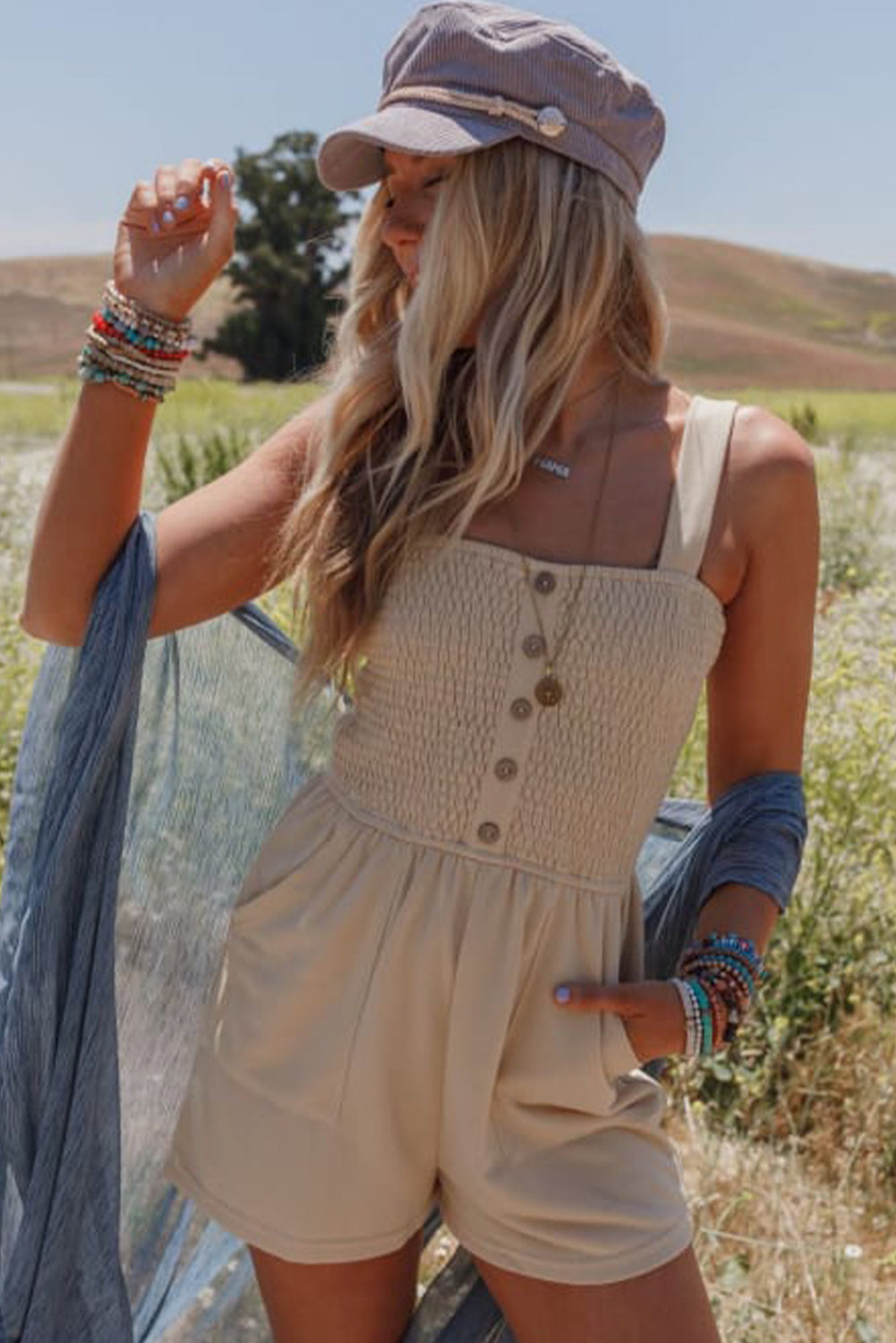 Beige Solid Color Buttons Smocked Sleeveless RomperMaterial:85%Polyester+10%Cotton+5%Elastane

• Its high waist design adds a flattering touch to any silhouette.
• Embrace the versatility of this romper with its sl